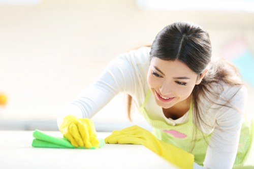 Team member using ventilation and safe chemical handling during cleaning